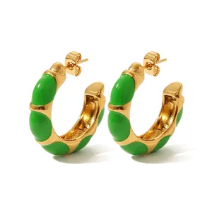 Detail view of 2.7cm green enamel and gold plated stainless steel C-shape hoop earrings