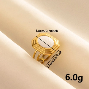 Vintage 304 stainless steel gold ring with white enamel octagon face on silk background