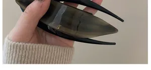 Detailed view of large acetate hair claw clip with black and brown tortoiseshell pattern