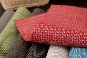 Detailed texture of thick woven PVC placemats in multiple colors for heat protection