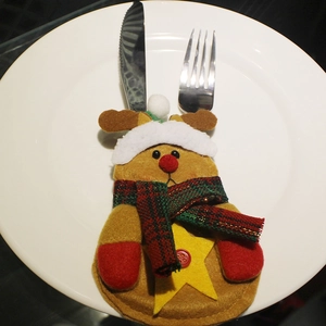 Reindeer Christmas cutlery holder for festive table decoration on a white plate.