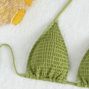Avocado green halter neck bikini top with shirred texture and beach vacation props