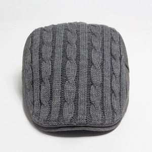 Thick knitted flat cap in dark grey with cable knit pattern for men and women