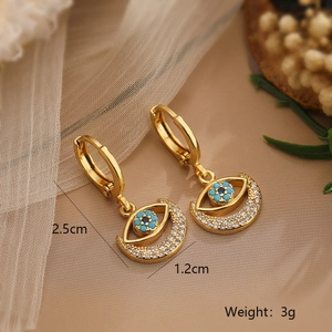 Detailed view of 18K gold plated hoop earrings with evil eye moon charm and zircon inlays