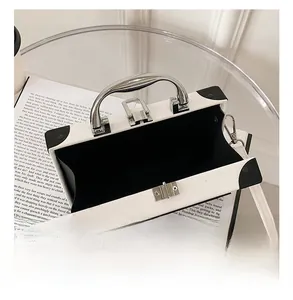 Detailed interior view of white radio-style trunk bag with silver hardware and black lining