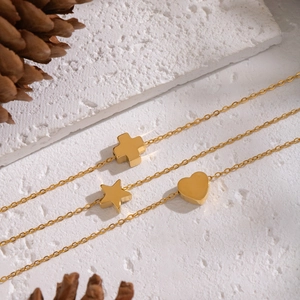 Elegant gold stainless steel necklace set with heart star and cross charms on stone