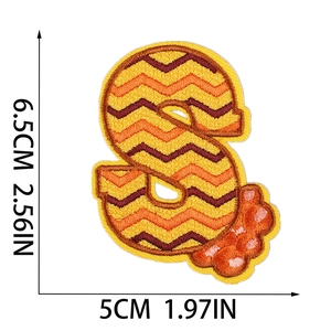 Detailed view of letter S embroidery patch with orange wave patterns and size dimensions