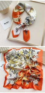 Detail of silk square scarf featuring orange floral prints, butterflies and cello patterns
