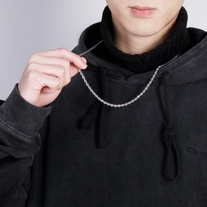 Minimalist silver stainless steel twist rope chain necklace worn by a model