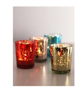 Macro shot of speckled mercury glass candle holders in gold, red, silver, and teal blue finish