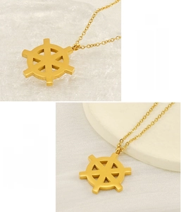 Macro view of 18K gold-plated stainless steel ship wheel pendant with durable finish