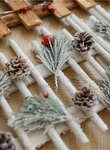 Macro detail of wooden Christmas fence with frosted pine needles and cones