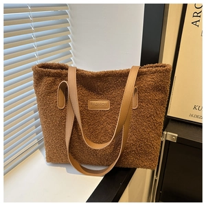 Detail of plush brown tote bag with FASHION leather label and PU shoulder straps