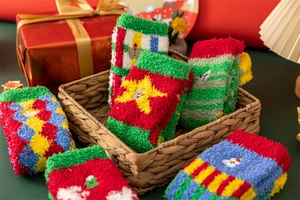 Detail of Christmas coral fleece socks with snowman patterns in a festive gift setting