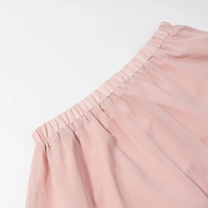Detail of pink chiffon set showing elastic waist with ruffled texture and soft fabric