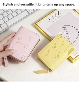 Pink and yellow mini organ wallets featuring cute cartoon bear patterns and zippers