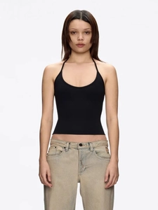 Minimalist black halter top with backless design paired with light wash denim jeans