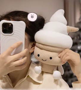 Close-up of cute ice cream plush toy with happy emoji face and waffle texture