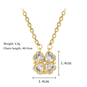 Detail of four-leaf clover pendant with heart-shaped crystals on a gold steel chain