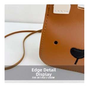 Close-up of the professional stitched edge and brown leather texture on bear bag