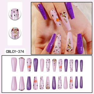 Halloween purple glitter coffin nails with pumpkin ghost patterns and rhinestone moon charms