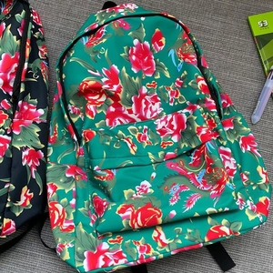 Detail of green floral canvas backpack with traditional Chinese peony and phoenix patterns