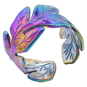 Macro shot of an adjustable leaf-shaped stainless steel ring with rainbow iridescent finish