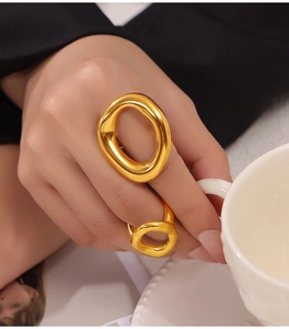Detail of minimalist irregular hollow gold rings with liquid metal style on hand