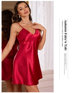 Detail of red satin slip dress featuring elegant V-neckline and smooth silk texture