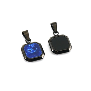 Detail of square stainless steel pendants with blue marble texture and matte black finish