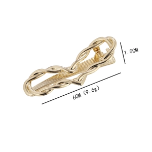 Golden minimalist heart-shaped metal hair clip with wavy design and size measurements