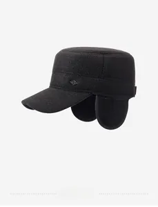 Detail view of black winter flat top hat with twill texture and metal diamond accent
