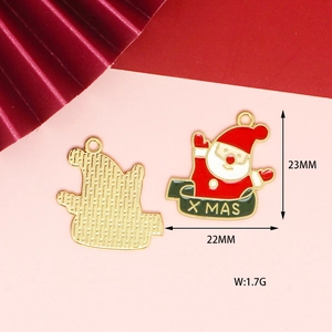 Detail of Santa Claus enamel alloy pendant with X MAS lettering and gold plated back