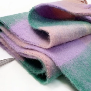 Detailed macro view of soft brushed mohair scarf with pastel purple and mint green plaid