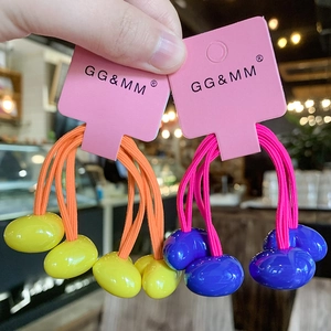 Detail of colorful elastic hair ties with heart beads on branded display cards