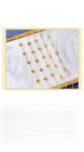 Detail of 18K gold-plated bracelets featuring butterfly, flower, and tree of life charms