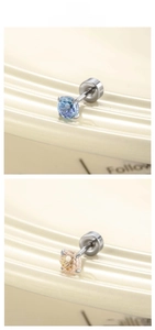 Macro detail of firework-cut zircon earrings in champagne and purple-blue colors
