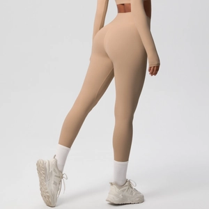 Detail view of high waisted beige yoga leggings with seamless athletic stretch fabric