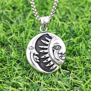 Punk style stainless steel sun and moon pendant necklace on a green grass background