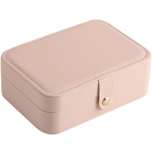 Pink cross-grain leather jewelry storage box with gold snap button on white background