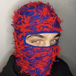 Distressed knit balaclava mask in red and blue contrast with fringe detail