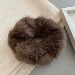 Close-up of soft brown faux mink fur scrunchie with a fluffy texture for women's hair