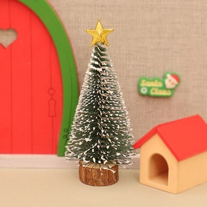 Miniature green Christmas tree with white snow, golden star top and round wooden base