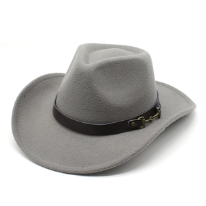 Detail of grey wool felt cowboy hat featuring a brown leather band and gold horsebit buckle