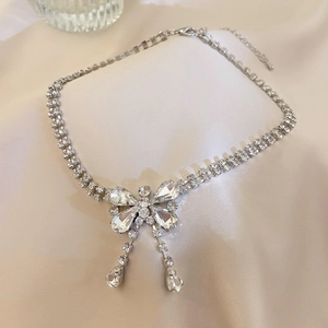 Close-up of sparkling silver butterfly pendant necklace with teardrop zircon stones