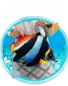 Detailed view of plush tropical fish toy with yellow fins and blue wave patterns