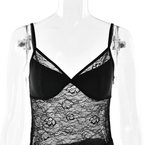 Close-up of intricate black floral lace patchwork and satin cups on women's bodysuit