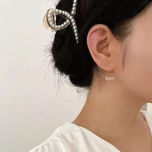 Detailed view of 3mm silver S925 sterling silver stud earrings with zirconia on ear
