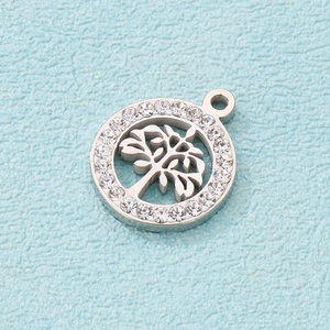 Close-up of a silver hollow Tree of Life pendant with sparkling zircon inlays