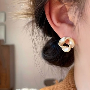 14K gold plated clover earrings with shell inlay and diamonds on a female model